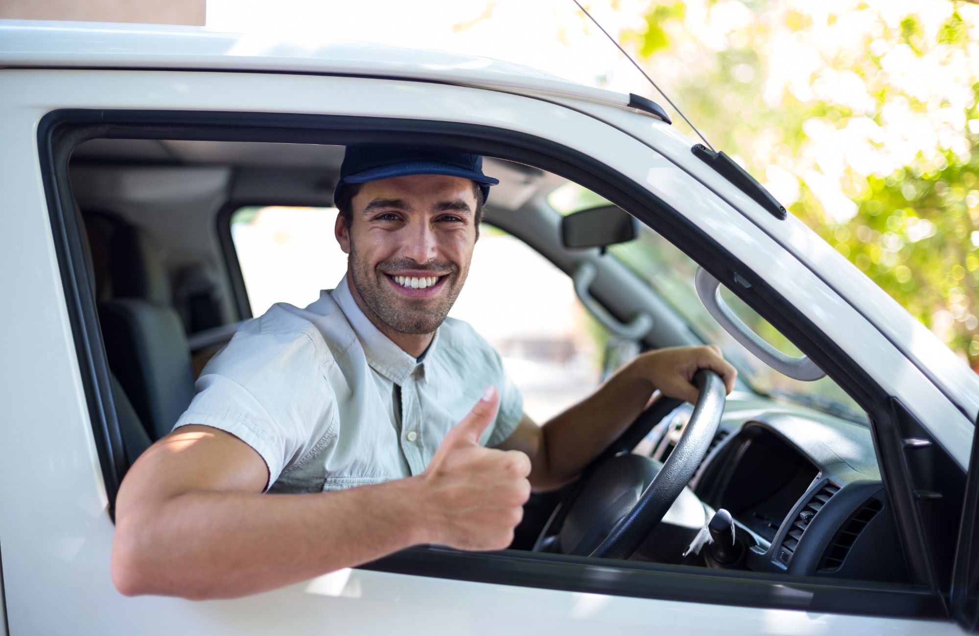 man in the van smiling to a camera